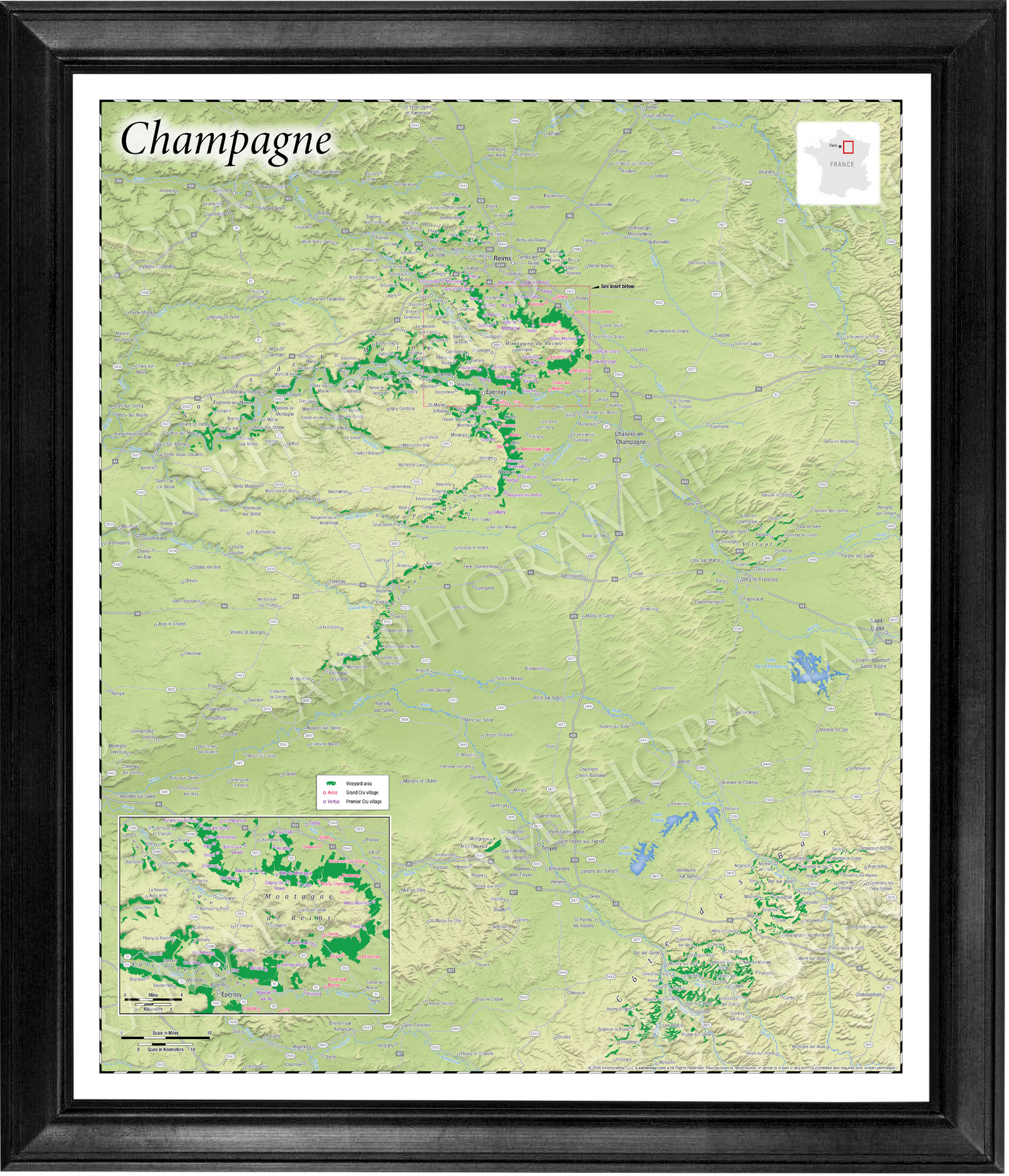 A framed topographical map of Champagne, featuring a light green and beige terrain design with green river valleys, enclosed in a black frame with a white mat border.